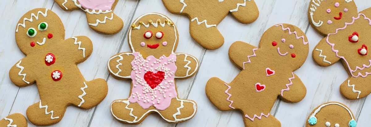 Gingerbread men and women shaped biscuits with pink icing representing loyal customers